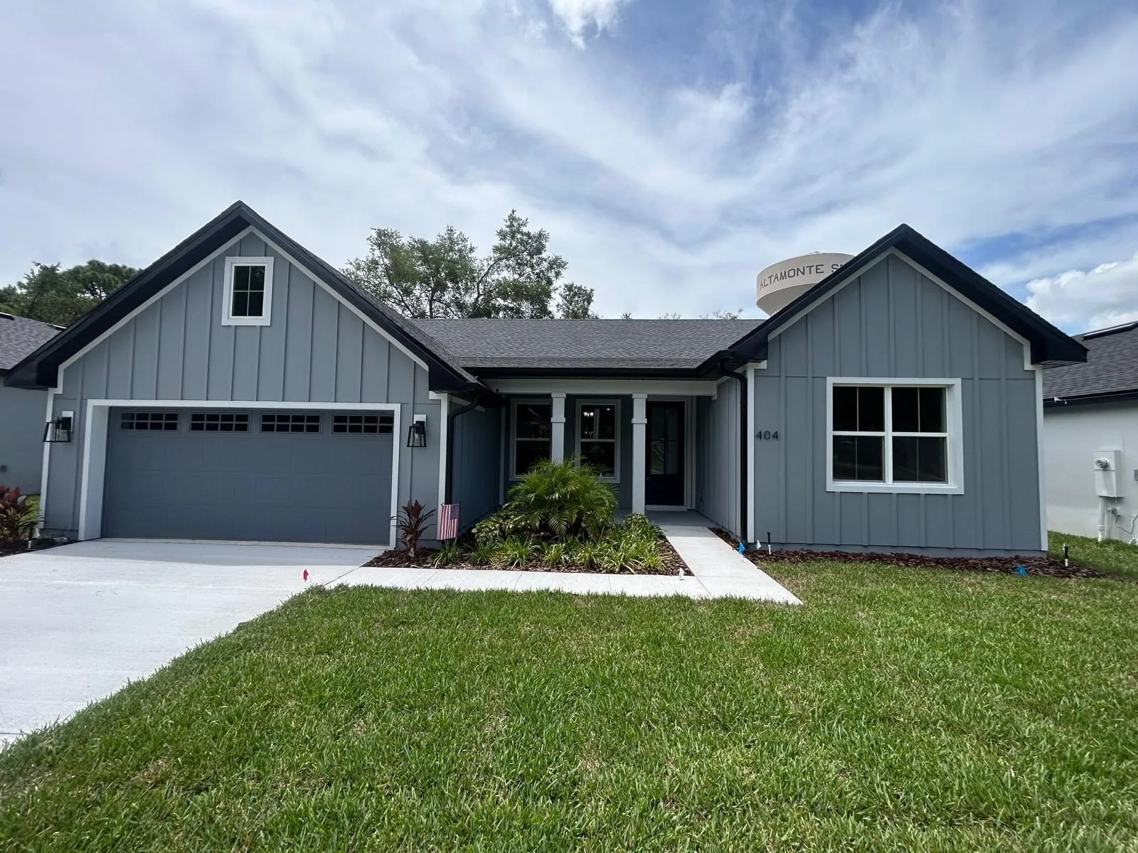 Single-story Florida home with gray board-and-batten fiber cement siding and white trim, installed by Endless Siding
